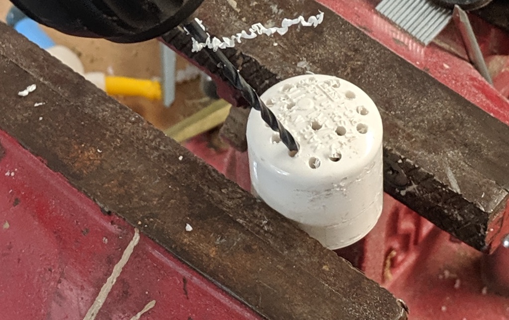 Image of drilling the holes in the top cap.
